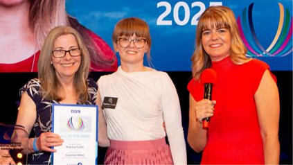 A picture of Caroline White, left, holding her winning certificate, alongside Katrina, centre, who nominated her, and All in the Mind presenter, Claudia Hammond, right.